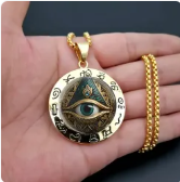 Gold-tone circular Egyptian-inspired Eye of Horus glass pendant necklace
