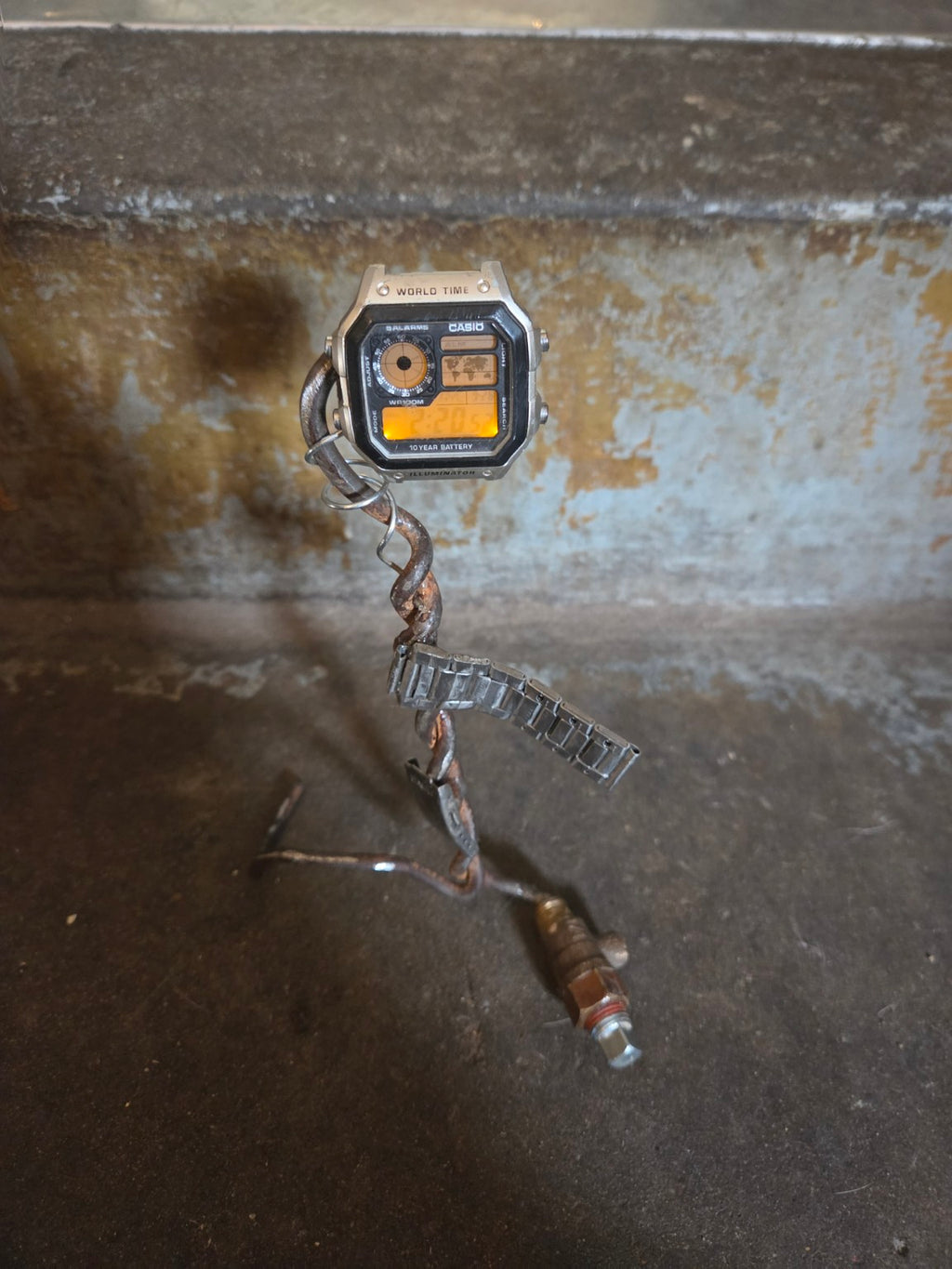 Casio World Time watch illuminated on handmade industrial sculpture